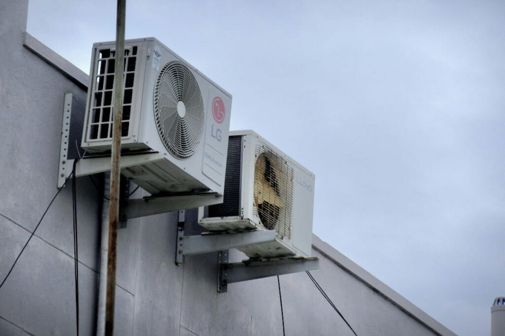 A professional technician HVAC system and a mini-split AC unit, installed thanks to the usage of a checklist for AC maintenance.