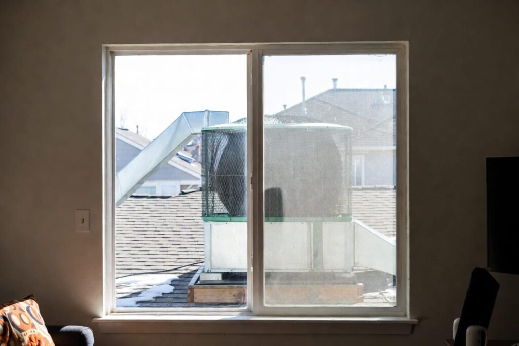 A swamp cooler in a rooftop seen from a dry living room, suggesting the swamp cooler can be used as a humidifier in winter.