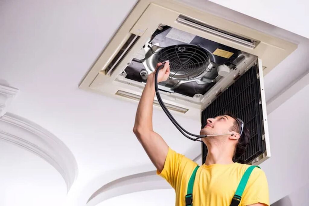 A person doing cleaning and maintenance to his HVAC system, showing the best way around how to clean HVAC ducts.