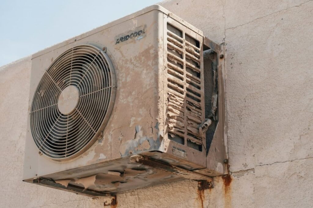 An outdoor air conditioning unit filled with dust, as an example of how dust storms can affect AC and HVAC systems.